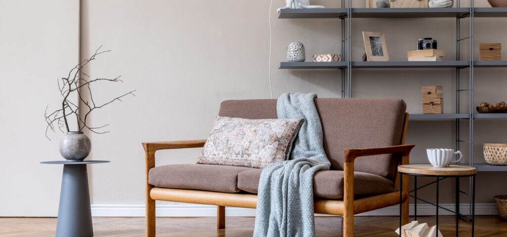 Two-seater small wooden couch with cushioned seating in a minimalist living room, showcasing natural wood tones and simple, elegant design